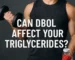 Athlete curling a dumbbell while holding a jar of red tablets with the headline “Can Dbol affect your triglycerides?”